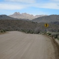 I ride through the shade of a dark cloud as I descend Black Canyon Road toward Cedar Canyon Road