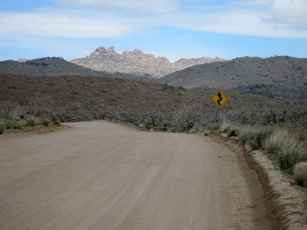 I ride through the shade of a dark cloud as I descend Black Canyon Road toward Cedar Canyon Road