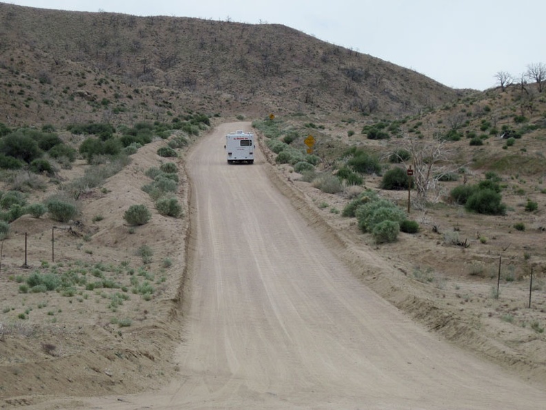 I watch a small RV rattle its way up, at about 5 miles per hour, the washboarded hill of Black Canyon Road that I just descended