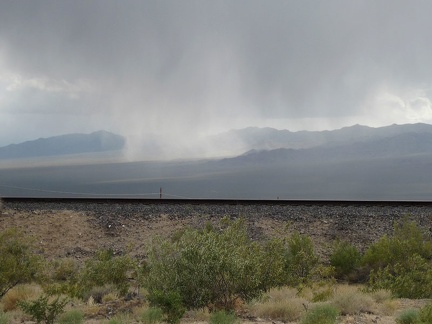 From Nipton, I see rain clouds over the area of Morning Star Mine Road, site of my nice downhill ride a couple of hours ago