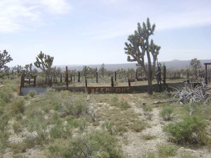 The walls around the corral out back send a prominent "keep out" message