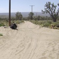 I return to the 10-ton bike in the sand trap on the old Cima Road
