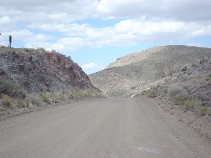 Ivanpah Road rises over the pass and begins its slow descent down into the valley