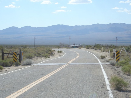  With relief, I'm back on the paved part of Ivanpah Road now and I'm letting the bike gain speed as I ride down the smooth hill