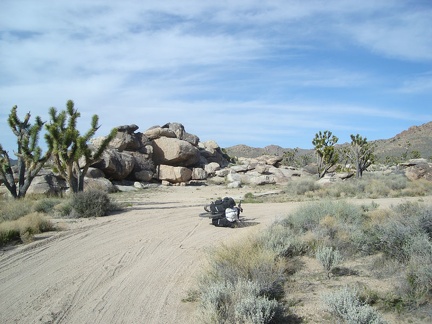A half-mile down the dirt road, I select a campsite to left of the big rock pile here