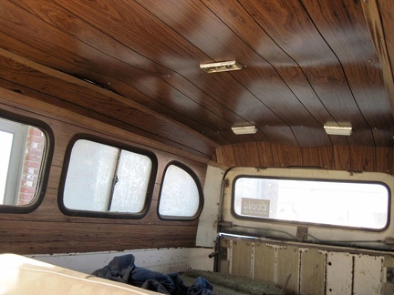 Faux wood paneling in the back of the old van, sagging a little