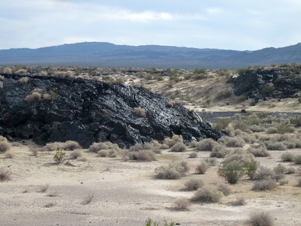 This lava outcrop along old Route 66 glistens in front of its Rodman Mountains Wilderness Area background