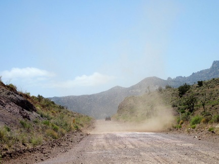 An uphill car passes me as Ivanpah Road begins its descent into Ivanpah Valley