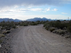 Nipton-Desert Road comes out from under a few dark clouds as I ride toward Primm