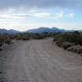 Nipton-Desert Road comes out from under a few dark clouds as I ride toward Primm