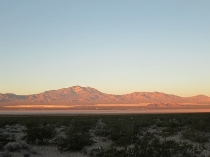 As the sun rises, the light cast on the Clark Mountain Range slowly morphs from pink to orange