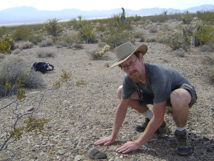 I stop to touch the rocky ground beneath me on the way back to Nipton