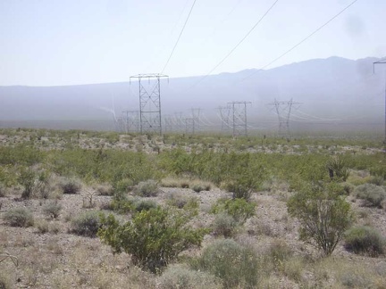 Off in the distance further down the power-line road, I see wafting trails of dust