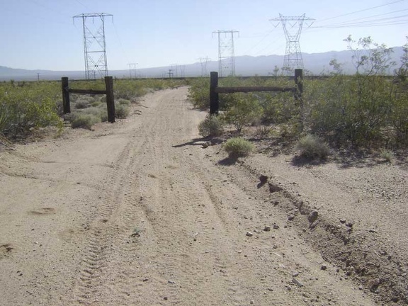At the bottom of the hill, the power-line road passes through an old ranch fence