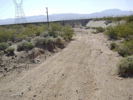 The power-line road goes right under the train tracks