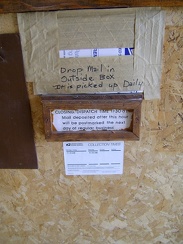 The interior mail slot taped shut, I follow the instructions and drop my mortgage payment in the mailbox outside