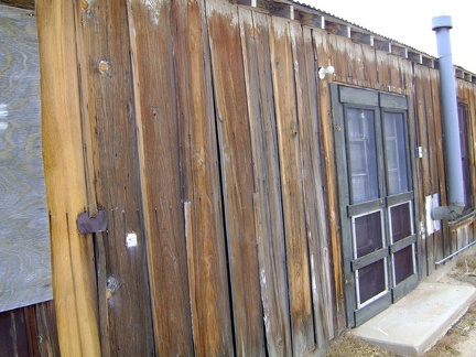 The heavily weathered board-and-batten exterior of the Cima store is in need of restoration work