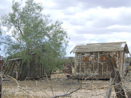 Two very crooked old sheds rest on the property behind the Cima store