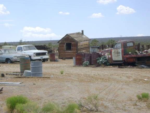 More old motor vehicles, and another crooked shed, behind the Cima Store, Mojave National Preserve