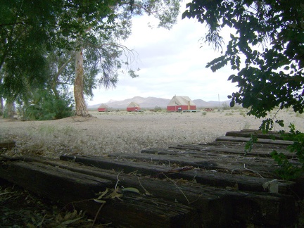 Behind my tent at Nipton lays a series of old railroad ties concealing a stinky septic leach field, and a few tent cabins beyond