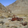 Just beyond the cabin rests an abandoned old truck