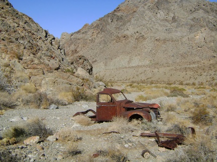 Just beyond the cabin rests an abandoned old truck