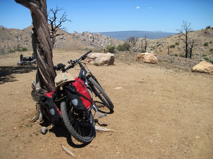 I do a test ride to a nearby campsite after fixing the bike's misaligned rear wheel; nice view of Cima Dome from this site