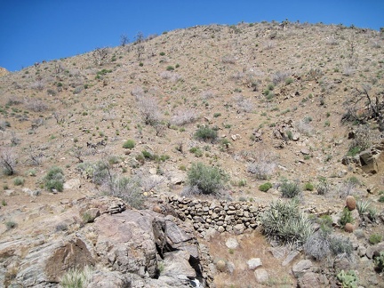 At the drop-off into Beecher Canyon, I spot a historic stack of rocks that once shored up a bypass road around the drop-off