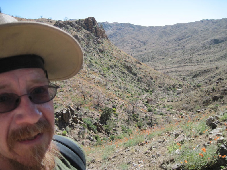 Climbing up the steep hillside to get around the spring in Beecher Canyon is challenging but I eventually find myself above it