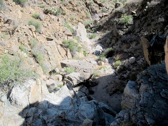 I take a short break after climbing the dry waterfall in Beecher Canyon and look back down at my progress