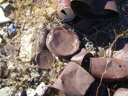 An old Copenhagen tobacco lid rusts quietly amongst other, less identifiable, cans at the old Rex Mine site