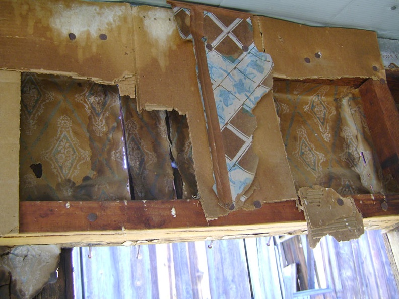 A closer look at the wallpaper, cardboard, and wallpaper interior at the Rex Mine boxcar cabin