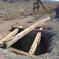 Along the trackway is an open shaft and the main headframe, with the Providence Mountains in the background