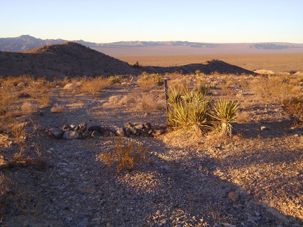 The old road passes an official Wilderness marker (non-Wilderness begins here) with the Rex Mine headframe in sunset silhouette