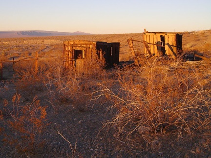 Passing the Rex Mine boxcar cabins under the red glow of sunset