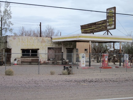 An old Italian restaurant and gas station sits in Newberry Springs behind a fence