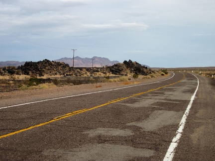 I ride up a gentle hill through the lava field area of old Route 66 east of Newberry Springs