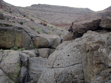 Camouflaged in the rocks is a small concrete dam to retain water running down from the hills