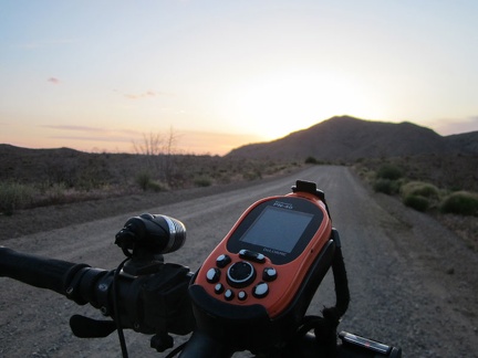 The sun hides behind Columbia Mountain as I ride up Wild Horse Canyon Road