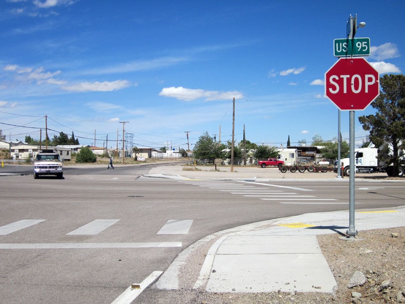 After seven miles, I arrive at the stop sign: I arrive at Searchlight, Nevada, population 576