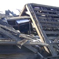 An old stove is crushed beneath the collapsed roof of this house at Cima, Mojave National Preserve