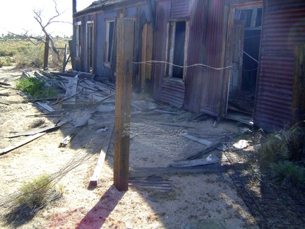 The front exterior of the collapsing house at Cima