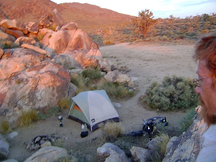 I hop around the rocks that surround my Cima Dome campsite and catch the pre-dusk orange desert glow