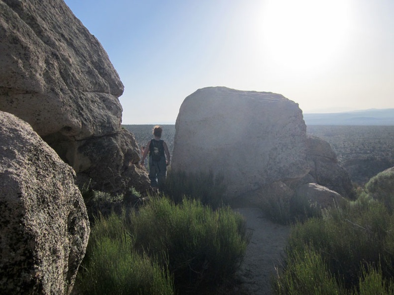 Heather walks between some of the boulders strewn about on Teutonia Peak