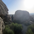 Heather walks between some of the boulders strewn about on Teutonia Peak