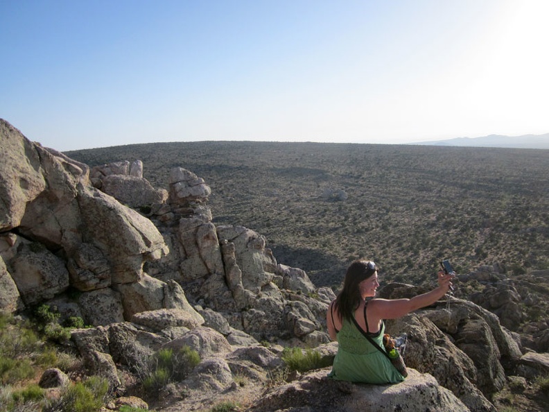 Sarah takes a break on Teutonia Peak, overlooking the subtle curve of Cima Dome