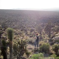 Heather stands on a Teutonia Peak "balcony" overlooking the Cima Dome curve