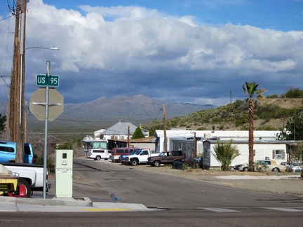 Looking down the street in Searchlight, I can see the forecast rain clouds hovering over the mountains where I'll be headed soon