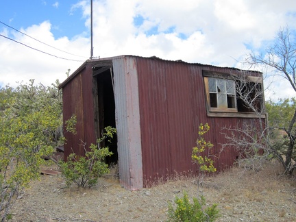 In the backyard sits a small outbuilding