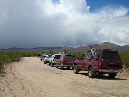 A row of 6 SUVs has stopped by the Walking Box Ranch, apparently preparing for a ride into the rain clouds ahead, like me